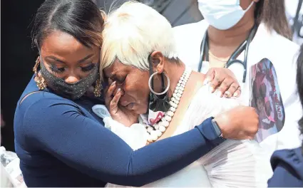  ?? JOE RAEDLE/GETTY IMAGES ?? Tomika Miller, right, leaves the service for her husband, Rayshard Brooks, who was killed by police in Atlanta on June 12.