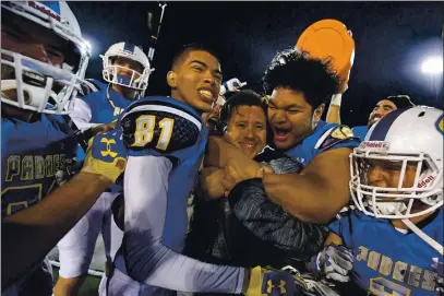 ?? JOSE CARLOS FAJARDO — BAY AREA NEWS GROUP ?? Serra head coach Patrick Walsh is mobbed by his players after defeating Cajon during their 2017 CIF State Football Championsh­ip Division 2-AA Bowl Game.
