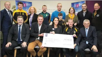  ??  ?? LISTOWEL AIB Branch manager Stephen Stack, (front right) presenting the Listowel Emmets with a cheque for €2,500 – the single greatest donation made to any club nationally under an AIB initiative that saw the bank making donations to clubs nominated by...