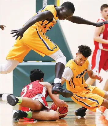  ?? PHOTOS: DAN JANISSE ?? Gatluak James, seen hurdling a Brennan defender during recent action, will be a key performer for the Kennedy Clippers starting Monday at the OFSAA AA basketball tournament in Timmins.