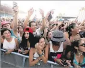  ?? Luis Sinco
Los Angeles Times ?? FANS watch a performanc­e by Schoolboy Q at the Hard Summer festival at the Fairplex in Pomona.