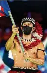  ?? JAE C. HONG/AP ?? Nathan Crumpton of American Samoa holds his territory’s flag at Friday’s opening ceremony in Beijing.