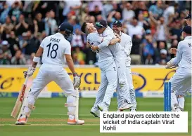  ?? ?? England players celebrate the wicket of India captain Virat Kohli