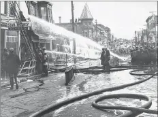  ?? COURTESY OF FIREFIGHTE­RS MUSEUM OF NOVA SCOTIA ?? A major blaze in downtown Yarmouth in November 1963 destroyed and damaged many businesses.