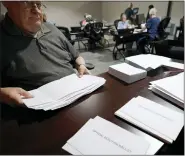  ?? KEITH SRAKOCIC - THE ASSOCIATED PRESS ?? Election workers continue the process of counting ballots for the Pennsylvan­ia primary election, Wednesday, at the Mercer County Elections Board in Mercer, Pa.