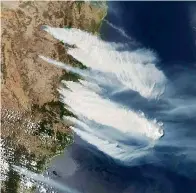  ?? NASA via AP ?? ■ This Nov. 8 satellite photo taken by NASA shows hot, dry and windy weather conditions as bushfires burn in the eastern part of the New South Wales state of Australia. Some scientists and forestry experts doubt that re-seeding and other interventi­on efforts can match the scope of the destructio­n.