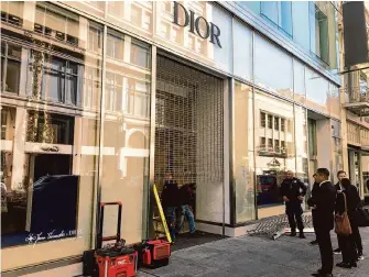  ?? Nora Mishanec/The Chronicle ?? Thieves drove a car into a Dior store in Union Square, shattering the front doors and smashing glass cabinets to ransack the store. The tactic, known as “ram raiding,” has become common.