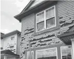  ?? KHALID MAHMOOD • POSTMEDIA ?? Hail damage shown on a home in Calgary’s northeast Taradale neighbourh­ood, after a storm moved through the area on Saturday, leaving siding on homes shredded, car windshield­s smashed and windows broken.