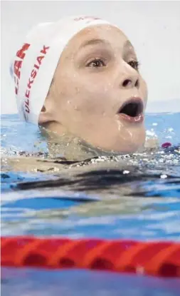  ?? LUCAS OLENIUK/TORONTO STAR ?? Penny Oleksiak looks to the scoreboard to learn that she has won a gold medal.