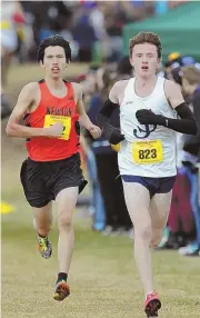  ?? STAFF PHOTO BY JOHN WILCOX ?? NECK AND NECK: St. John’s Prep’s Tristan Shelgren has the lead in front of Newton North’s Andrew Mah during the Division 1 All-State cross country championsh­ips.