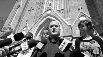  ?? — Photo by The Canadian Press ?? Ste-Agnes parish church father Steve Lemay speaks to reporters prior to a memorial celebratio­n for the victims of a train crash and subsequent fire in Lac-Megantic, Que., Saturday.