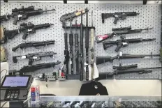  ?? ANDREW SELSKY/AP in Salem, Ore., on ?? FIREARMS ARE DISPLAYED AT A GUN SHOP Feb. 19, 2021.