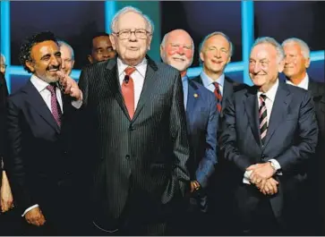  ?? J. Countess Getty Images ?? BILLIONAIR­E Warren Buffett, second from left, told Yahoo News in April that newspapers are “toast.”