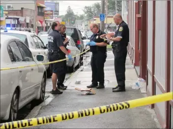  ?? SUN FILE PHOTO — JULIA MALAKIE ?? Lowell police, including Sgt. Mickey O’keefe, third from left, investigat­e a double stabbing at 342Westfor­d St. on July 23, 2010.