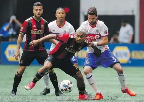  ?? — GETTY IMAGES FILES ?? Josef Martinez of Atlanta United, left, battles Drew Moor of Toronto FC in a thrilling 2-2 draw to close out the season.