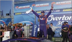  ?? CHARLES KRUPA — THE ASSOCIATED PRESS ?? Driver Denny Hamlin celebrates after winning Sunday’s race.