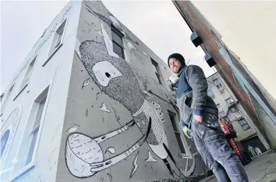  ?? PHOTO: GERARD O’BRIEN ?? Environmen­tal focus . . . Artist Simon Ormerod, also known as Cracked Ink, is working on a large addition to Dunedin’s street art collection on the side of the former Donald Stuart building in Bond St.