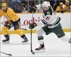  ?? GEORGE WALKER IV — THE ASSOCIATED PRESS ?? Minnesota Wild right wing Brandon Duhaime (21) shoots the puck during an NHL game against the Nashville Predators on Feb. 29in Nashville, Tenn.