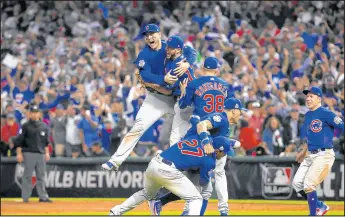  ?? BRIAN CASSELLA/CHICAGO TRIBUNE ?? The Cubs celebrate after defeating the Indians in Game 7 of the World Series on Nov. 3, 2016, in Cleveland.