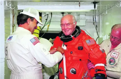  ?? AFP ?? Technician­s prepare John Glenn, 77 years old at the time, before he boards the US space shuttle Discovery on October 9, 1998.