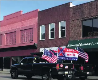  ?? Natalie Janicello for The National ?? Pickup trucks with the Confederat­e flag and emblems of white supremacis­ts drive up Main Street in the small North Carolina town of Roxboro during the Klan rally.