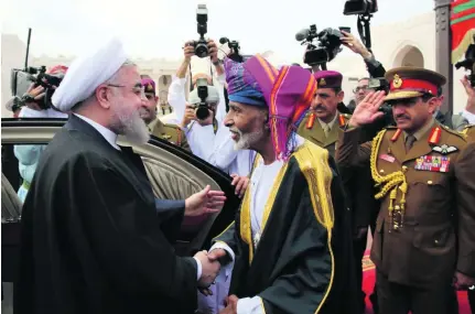  ?? Reuters ?? Iran’s president Hassan Rouhani is greeted by Oman’s Sultan Qaboos on his arrival in Muscat.