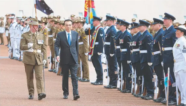  ?? Picture: KYM SMITH ?? OVERDUE VISIT: Chinese Premier Li Keqiang is given a ceremonial welcome at Parliament House in Canberra yesterday.