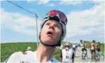  ?? PETER DEJONG/THE ASSOCIATED PRESS ?? Four-time Tour de France champion Chris Froome grimaces after being treated for tear gas or pepper spray.