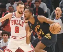  ?? JOHN J. KIM/CHICAGO TRIBUNE ?? Bulls guard Zach LaVine defends Cavaliers center Evan Mobley in the first quarter Saturday at the United Center.