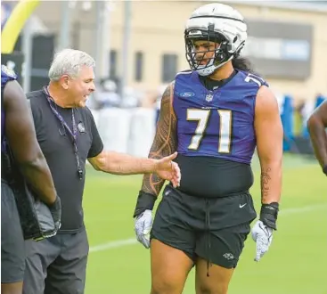  ?? KEVIN RICHARDSON/STAFF ?? Ravens offensive line coach Joe D’Alessandri­s gives instructio­ns to guard Malaesala Aumavae-Laulu, right, during training camp last year.