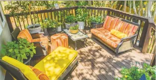  ??  ?? Colourful cushions and comfy furniture will make a deck a favourite spot to pass a shady afternoon on a summer day. If you have room for a fire pit, enjoy s’mores as the sun sets.