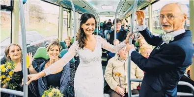  ??  ?? Wedding fare...Yvonne, her bridesmaid­s and father David on the bus on their way to the ceremony