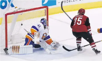  ?? ROSS D. FRANKLIN/THE ASSOCIATED PRESS ?? Arizona Coyotes centre Nick Cousins scores the OT game winner against New York Islanders goaltender Jaroslav Halak Monday in Glendale, Ariz.