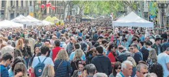  ?? FOTO: AFP ?? Ein Gedränge herrscht auf der Straße Las Ramblas in Barcelona am Tag des Heiligen Georg.