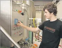  ?? THE CANADIAN PRESS/STEPHEN MACGILLIVR­AY ?? Callum Stewart, brewery operations manager at Grimross Craft Brewing, makes adjustment­s to their equipment at their business in Fredericto­n, N.B., earlier this month.