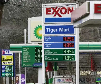  ?? SETH WENIG/ASSOCIATED PRESS ?? Gas prices are displayed at gas stations in Englewood, N.J., Monday, March 7, 2022. Gasoline prices are pushing even farther above $4a gallon, the highest price that American motorists have faced since July 2008, as calls grow to ban imports of Russian oil.