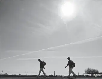  ?? CHARLIE RIEDEL/AP ?? The Mariners walk to the clubhouse after spring practice in 2020.