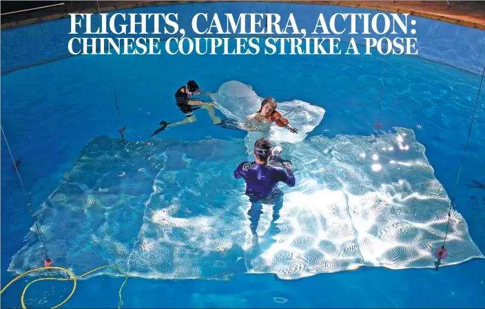  ?? PHOTOS BY REUTERS ?? Xu Jiaqian poses in a pool as she has a picture for her wedding photo series taken at the Qianyishi Underwater Photograph­y Studio in Beijing.