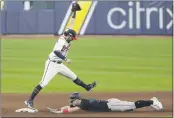  ?? MICHAEL WYKE — THE ASSOCIATED PRESS ?? The Braves’ Dansby Swanson makes forces out the Marlins’ Corey Dickerson during the eighth inning in Game 2of the NLDS on Wednesday in Houston.