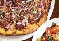  ?? Mike Sutter / Staff file photo ?? The Mexican-style Down South pizza incorporat­es chorizo, refried beans, pork al pastor, cilantro, onions, and cotija, mozzarella and provolone cheeses. This winner is found at Bootlegger­s Pizza Parlor in New Braunfels.