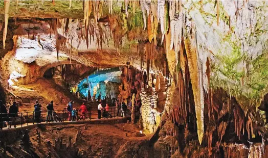  ?? Pictures: : ALAMY ?? What lies beneath: Visitors enjoying the Postojna caves — after a two-mile undergroun­d train journey