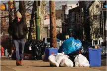  ?? AP Photo/Matt Rourke ?? ■ Trash sits out for collection Thursday in Philadelph­ia. The omicron variant is sickening so many sanitation workers around the U.S. that waste collection in Philadelph­ia and other cities has been delayed or suspended.