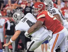  ?? ED ZURGA/AP ?? Raiders quarterbac­k Derek Carr is sacked by Chiefs defensive tackle Chris Jones on Monday in Kansas City, Mo. The Chiefs went on to win 30-29.