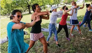  ?? Ben Torres / Dallas Morning News ?? From left, Sophia Kwong Myers and Amy Tran-Calhoun of the Dallas Women of Asian Descent make elbow strikes during a self-defense workshop last month at Flag Pole Hill Park in Dallas.