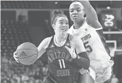  ?? MICHAEL CHOW/THE REPUBLIC ?? Arizona State guard Robbi Ryan (11) drives against Stanford forward Maya Dodson (15) at Desert Financial Arena March 1.