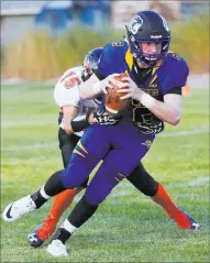  ??  ?? Pahranagat Valley quarterbac­k Tabor Maxwell picks up yardage during Friday’s victory over Wells.