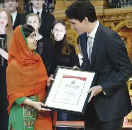  ?? CP PHOTO ?? Pakistani activist and Nobel Peace Prize winner Malala Yousafzai is presented with an honorary Canadian citizenshi­p by Prime Minister Justin Trudeau on Parliament Hill in Ottawa yesterday.