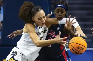  ?? MICHAEL CATERINA - THE ASSOCIATED PRESS ?? Notre Dame’s Natalija Marshall, left, and Mississipp­i’s Marquesha Davis fight for a loose ball on Monday.