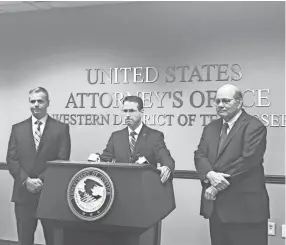  ??  ?? D. Michael Dunavant, U.S. Attorney for the Western District of Tennessee, with U.S. Postal Inspector Dwight Jones, left and Tony Arvin, assistant U.S. attorney, right, announce indictment­s against 13 people on federal mail theft charges. LINDA A. MOORE/THE COMMERCIAL APPEAL