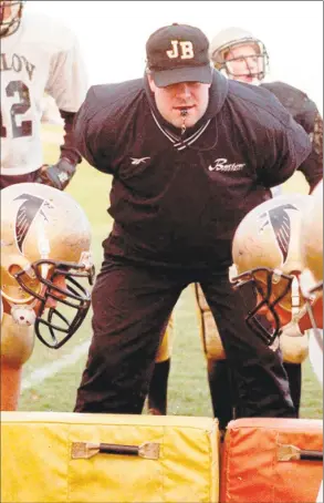  ?? David Harple / File photo ?? Barlow football coach Rob Tynan watches players at work.